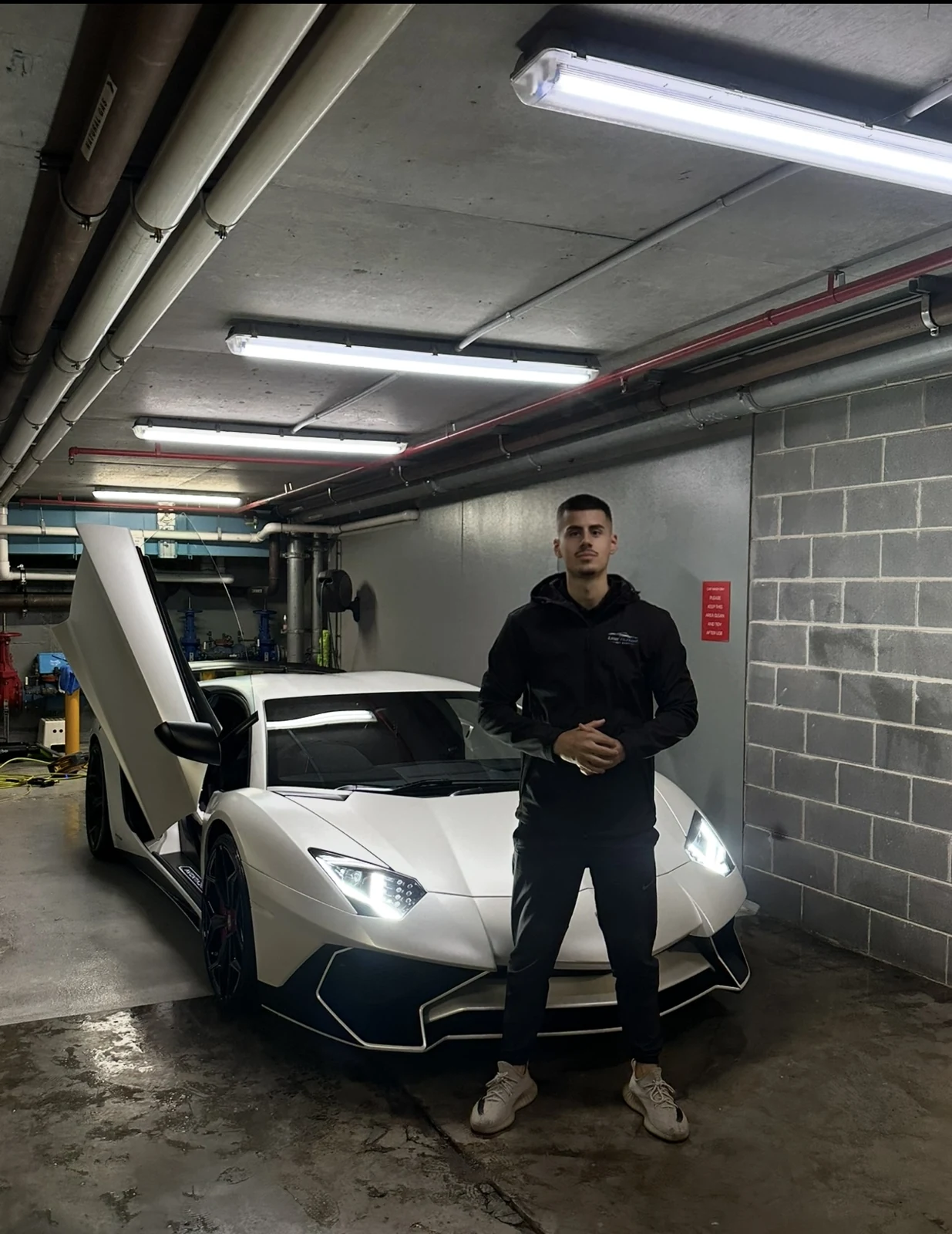 Victor with a white Lamborghini