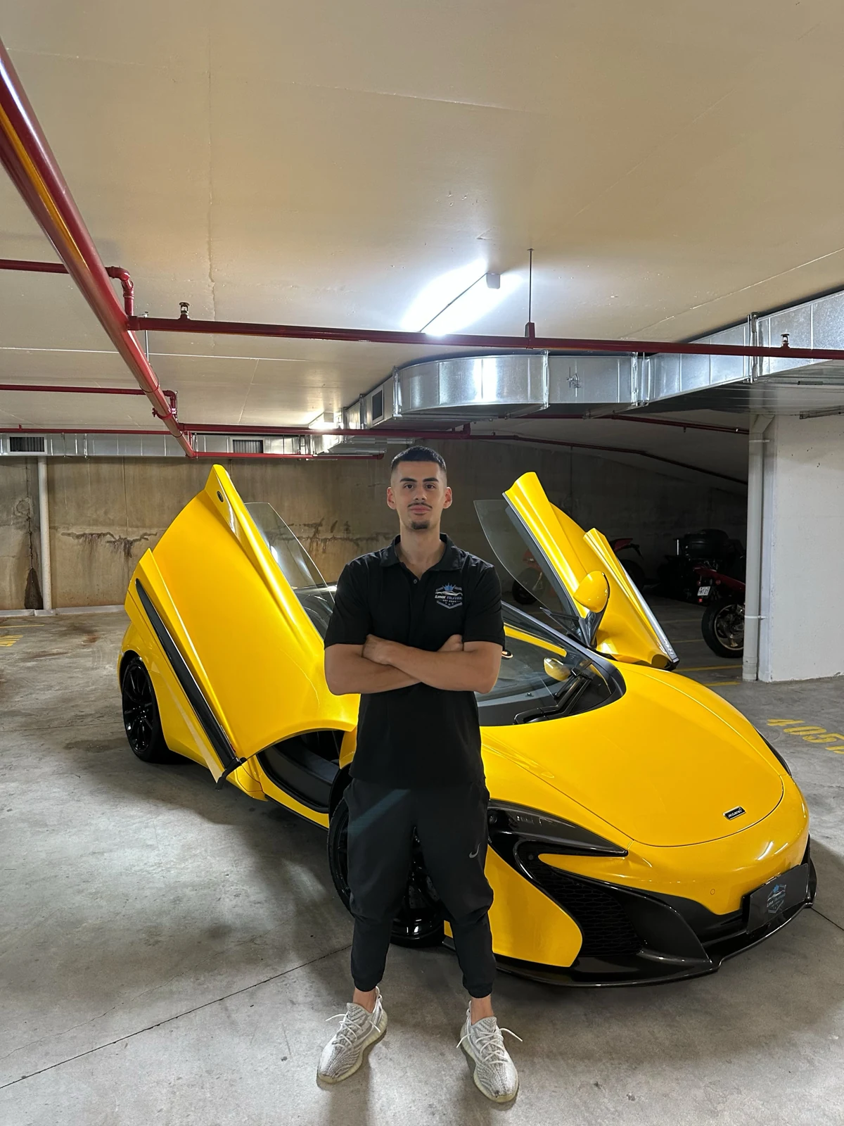 Lynx Autos portrait beside a yellow McLaren