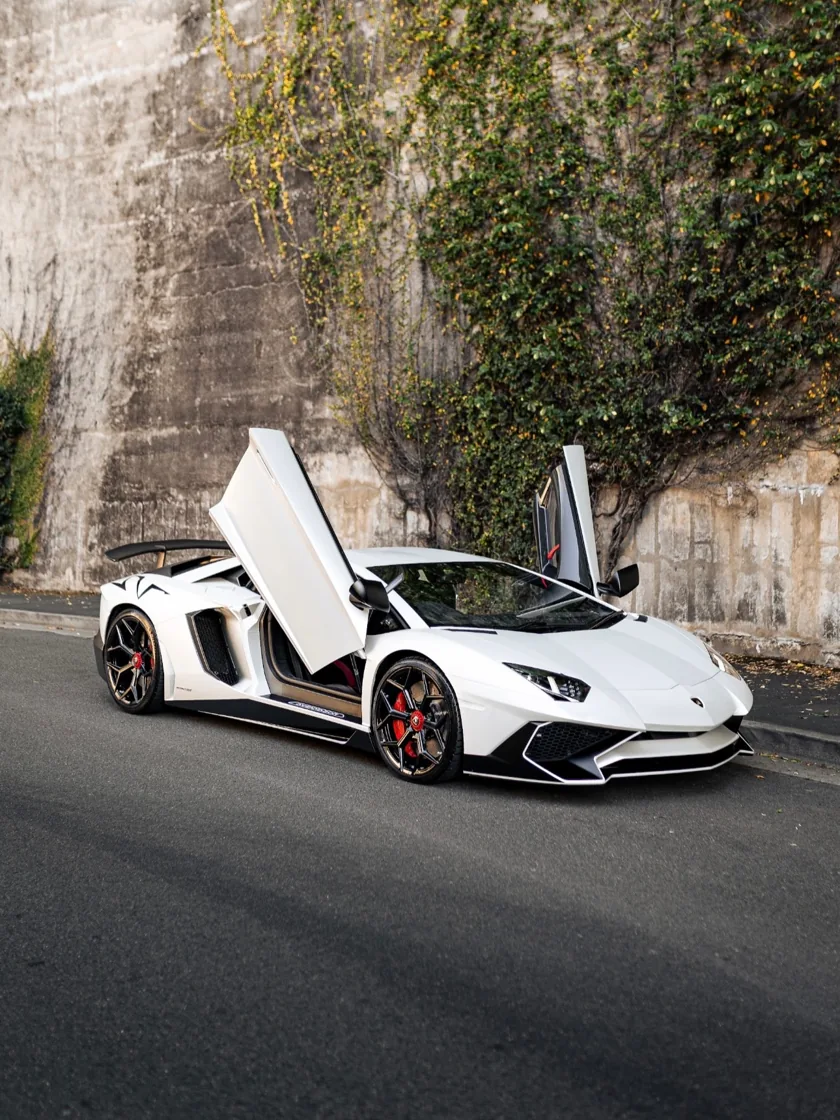 White Lamborghini Aventador SV with its doors open after detailing