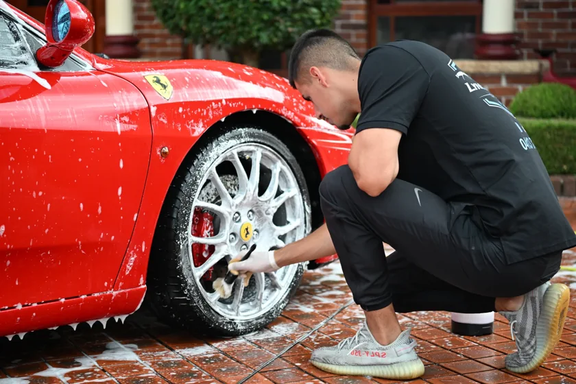 Close-up of a Ferrari wheel being cleaned by Lynx Autos